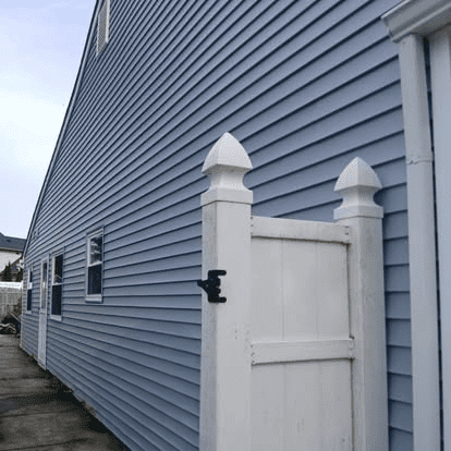 KPI blue siding with white gate Trust the experts at KPI Jr Exteriors for professional siding installation in PA & NJ.