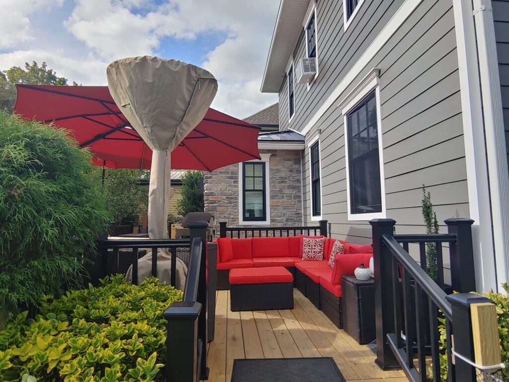 KPI deck with red cushions A pressure-treated wood deck adds outdoor space for homes across PA and NJ.
