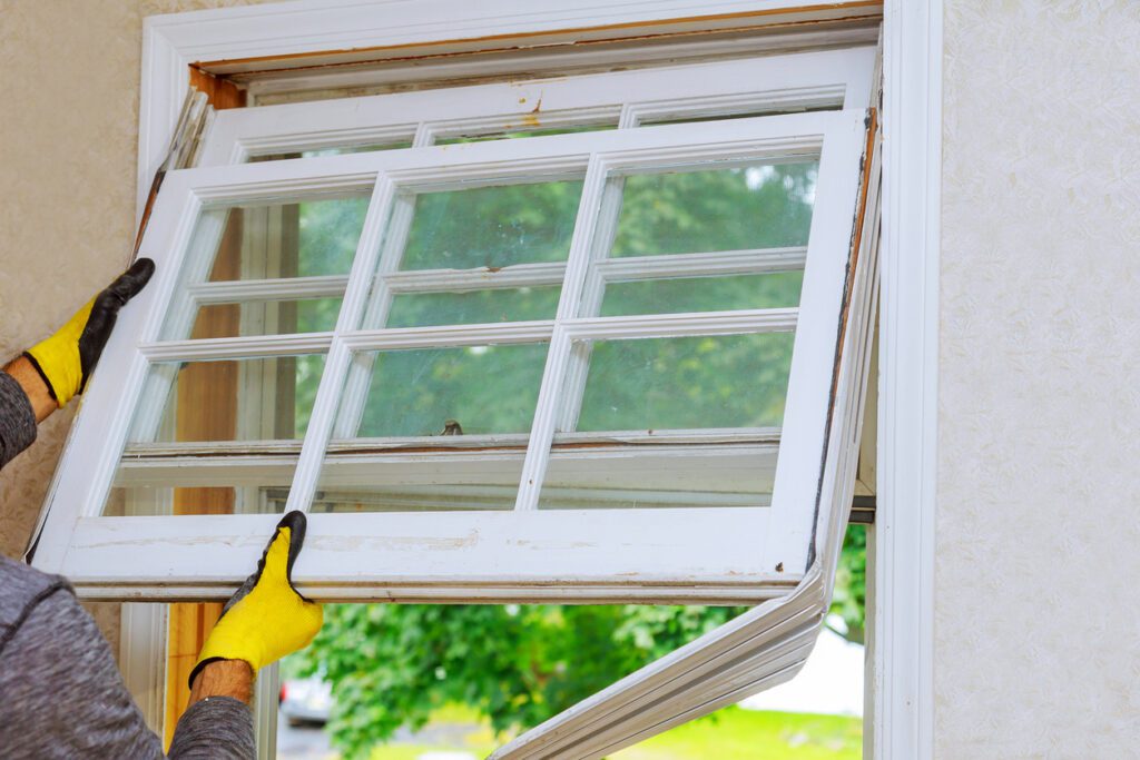 KPI replacing old window Technician removing old windows for a new window installation project