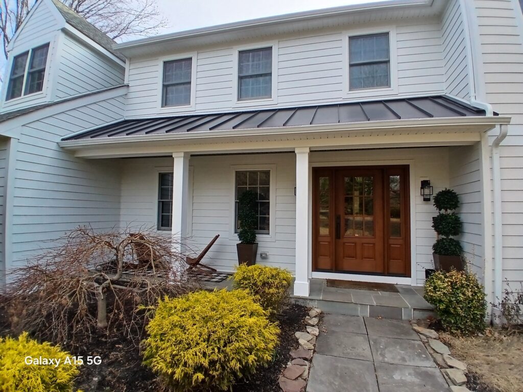 KPI white siding nice front porch Vinyl siding is a versatile and affordable option.